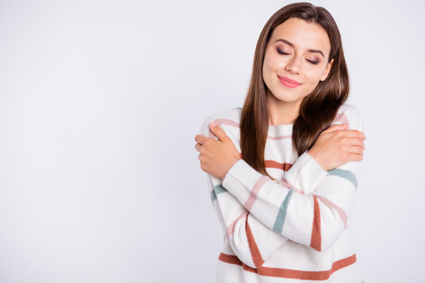 Photo of overjoyed lady, crossing hands touching nice striped pullover isolated white background